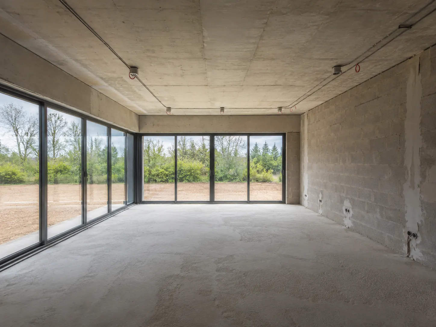 Unfinished living room with corner glazing before style transfer