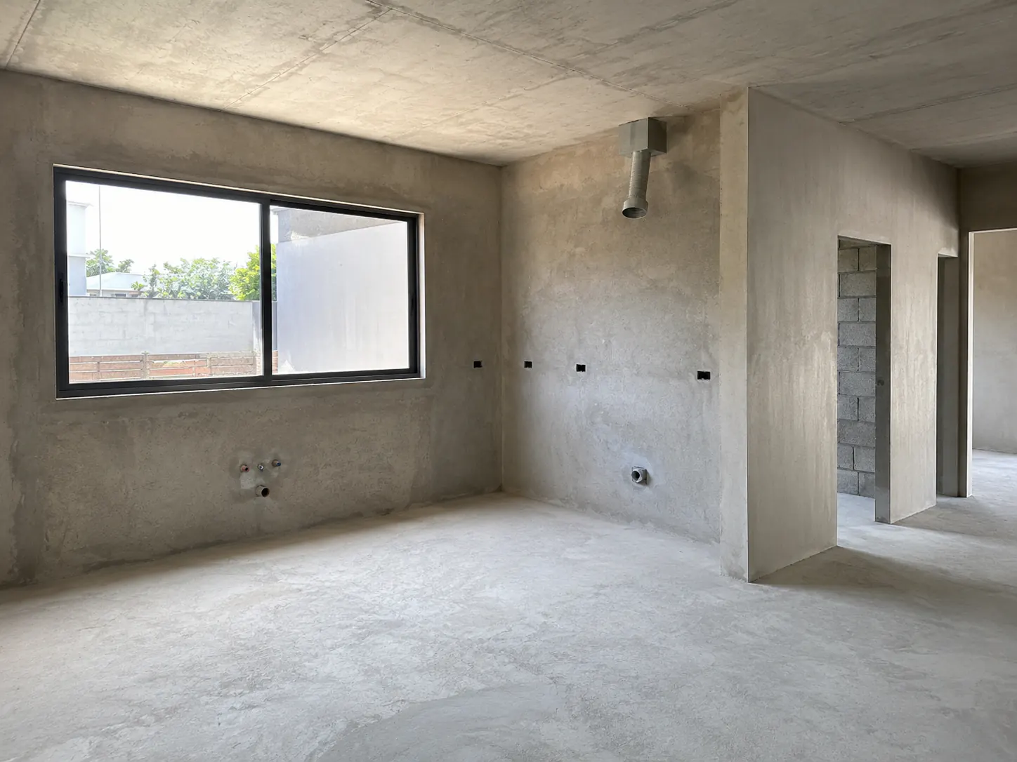 Unfinished L-shaped kitchen shell before redesign